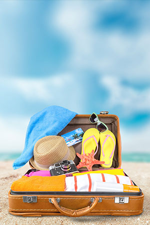 beach and suitcase with hat sunglasses camera towel clothes