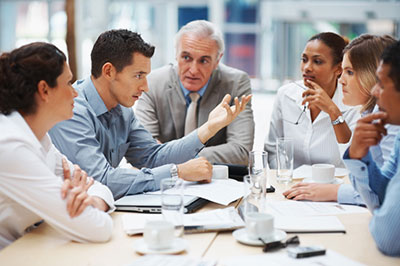 people meeting on a table to discuss  insurance