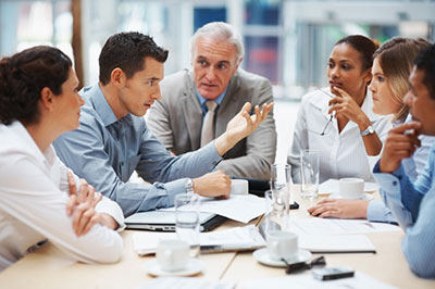 people meeting on a table to discuss insurance
