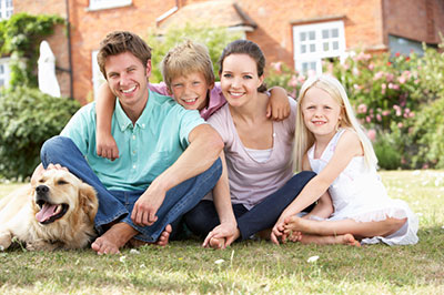 family together with dog and house background boy girl mom dad